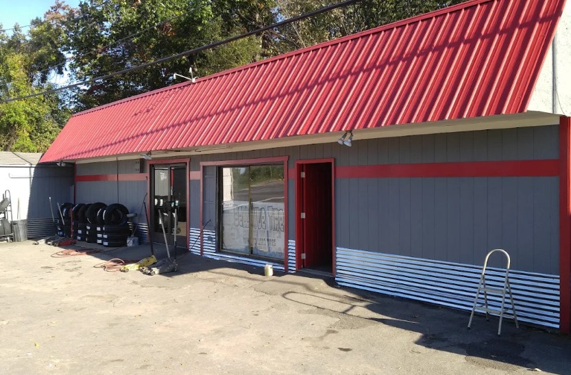 Redline Tire storefront with red roof and tire displays